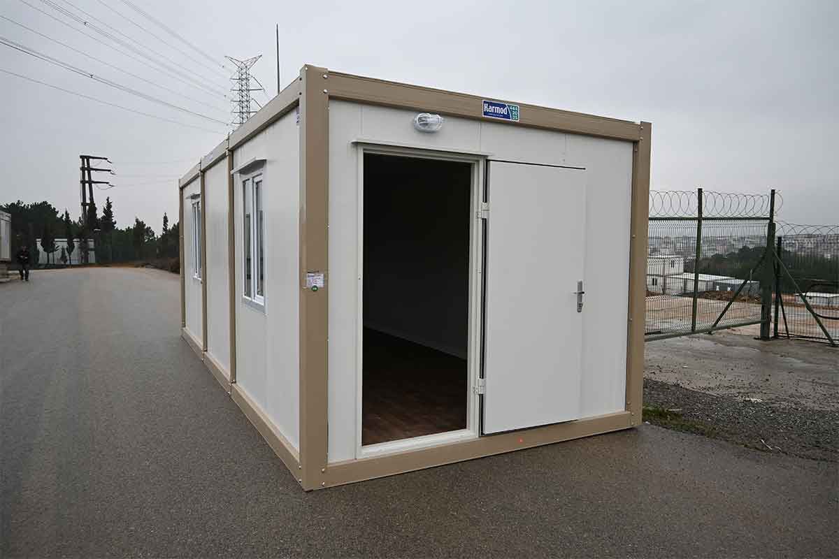 Standard container unit with its personnel door standing open, showing the wood-effect floor inside.