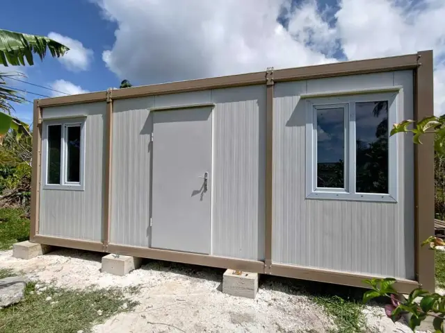 Container unit raised on concrete footings in a tropical garden, specified for humid conditions and heavy rainfall