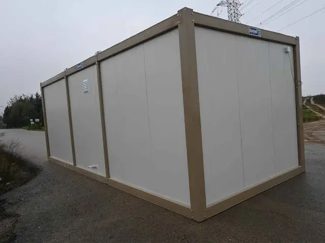 Windowless long side of a standard container unit with a single wall vent