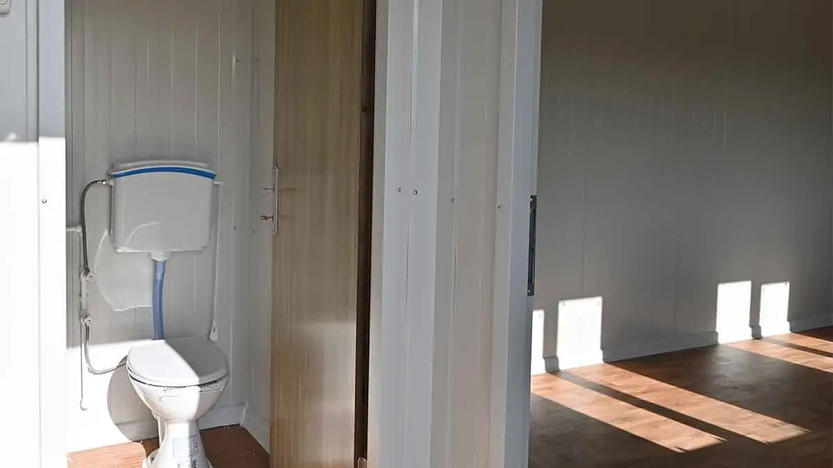 Partitioned WC compartment inside a standard container unit, plumbed and fitted before it leaves the factory