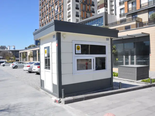 MetroCity security cabin on a paved forecourt in front of residential tower blocks