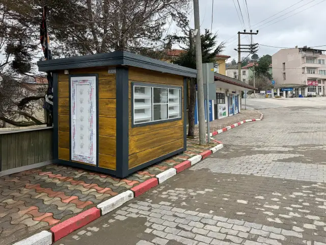 Timber-effect MetroCity kiosk fitted out as a municipal bread kiosk, with a glazed display window and shelving