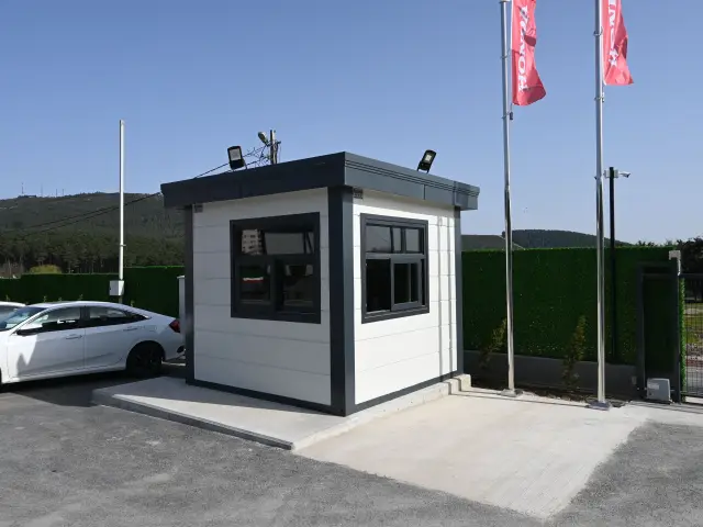 MetroCity gatehouse at a car showroom vehicle entrance with roof-mounted floodlights and cameras