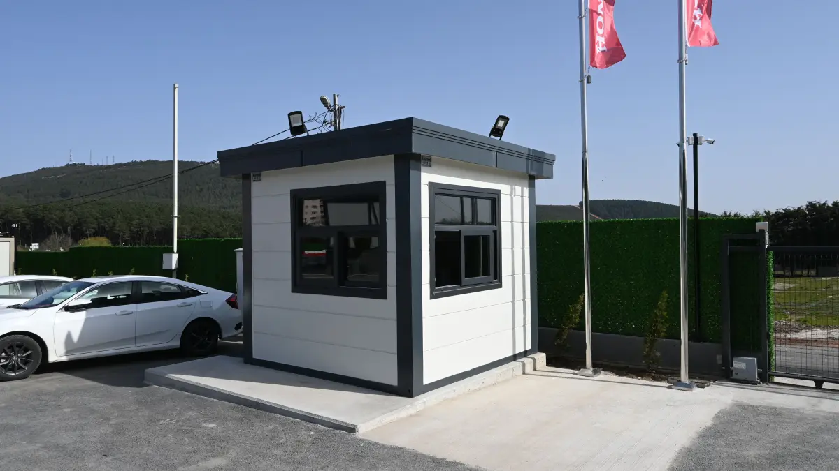 MetroCity gatehouse controlling the vehicle entrance to a car showroom, with roof-mounted floodlights and cameras