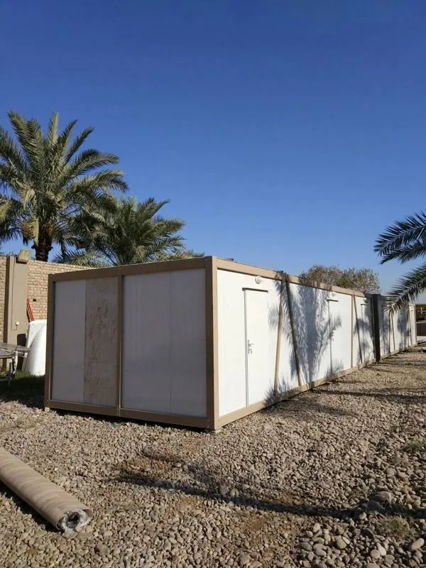 Row of container units on gravel among palm trees