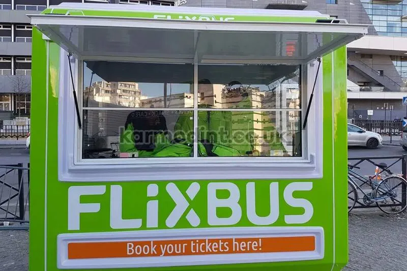 Green GRP ticket kiosk in FlixBus livery with its serving hatch open