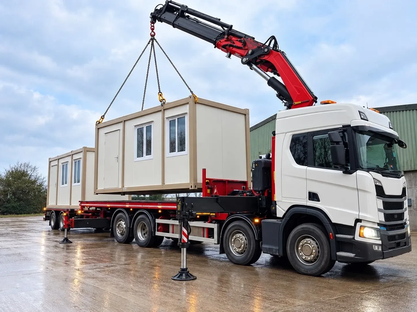 Two container units offloaded from a lorry-mounted HIAB crane